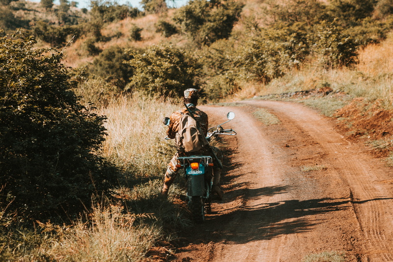 africa, dirt road, dirt, mode of transportation, growth, 5K, land vehicle, outdoors, nature, candid, real people, daytime, motorbike, sunlight, safari
