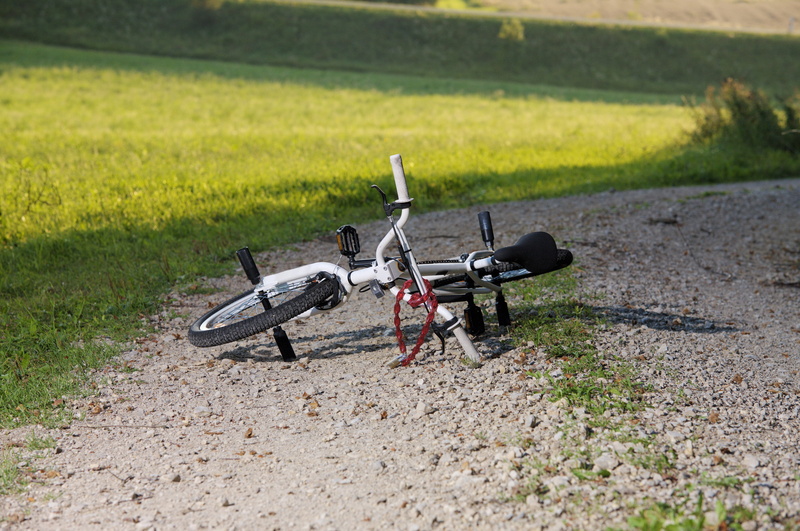 sunlight, grass, Bike, gravel road, Wheel, air vehicle, Away, mode of transportation, transportation, day, Bmx, green color, environment, stationary, land vehicle