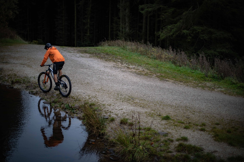 near, water, motion, dirt road, 5K, bicycle, one person, real people, day, human, machine, tarmac, slope, man, helmet, gravel, forest, tire, road, body