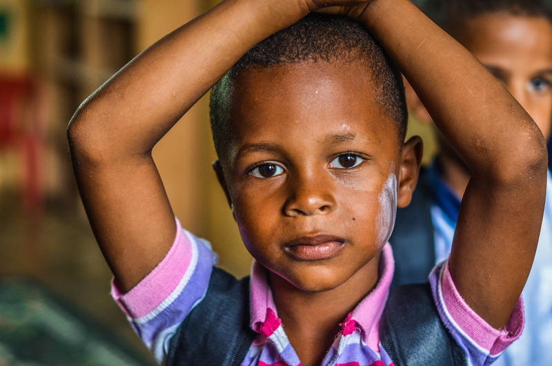 front view, arm bent, shirt, human face, collar, child, hands on head, one person, student, boys, arms raised, 4K, close, headshot, close-up, boy, portrait