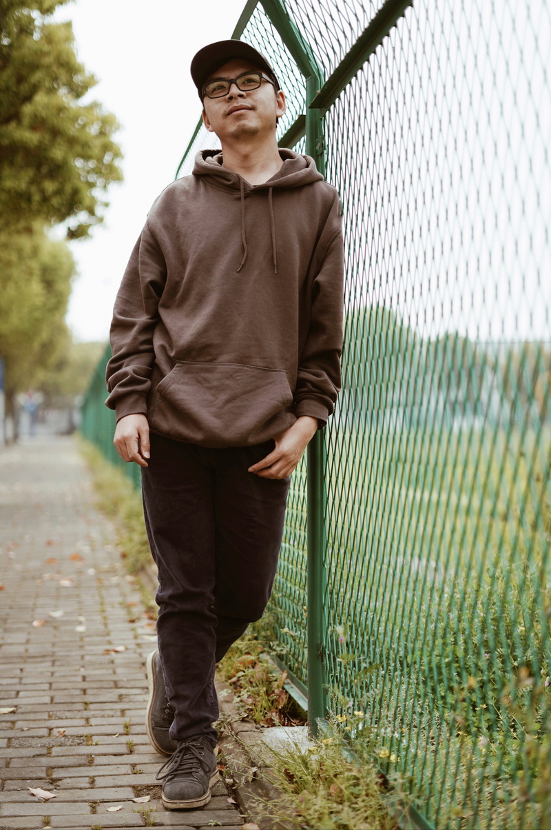 leisure activity, portrait, hoodie, barrier, front view, day, handsome, sleeve, footwear, outdoors, hood, footpath, sweater, 5K, standing, overcoat, jacket