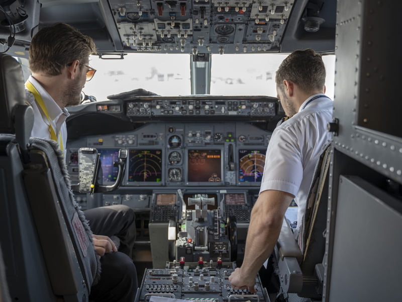 occupation, technology, sitting, co-pilot, cockpit, adult, vehicle interior, uniform, pilots, transportation system, rear view, aviation, flight, control