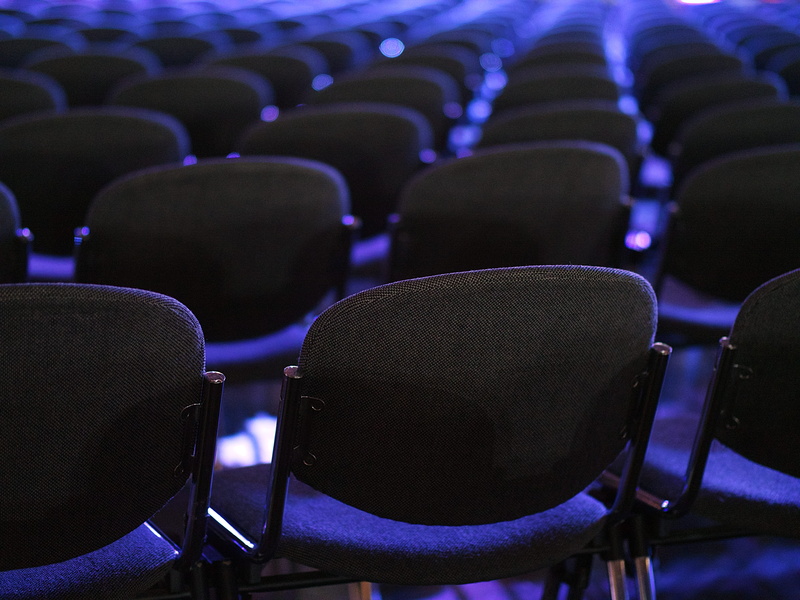 indoors, arts culture and entertainment, blue, focus on foreground, chair, conference, large group of objects, hall, black, chairs, anticipation, movie theater