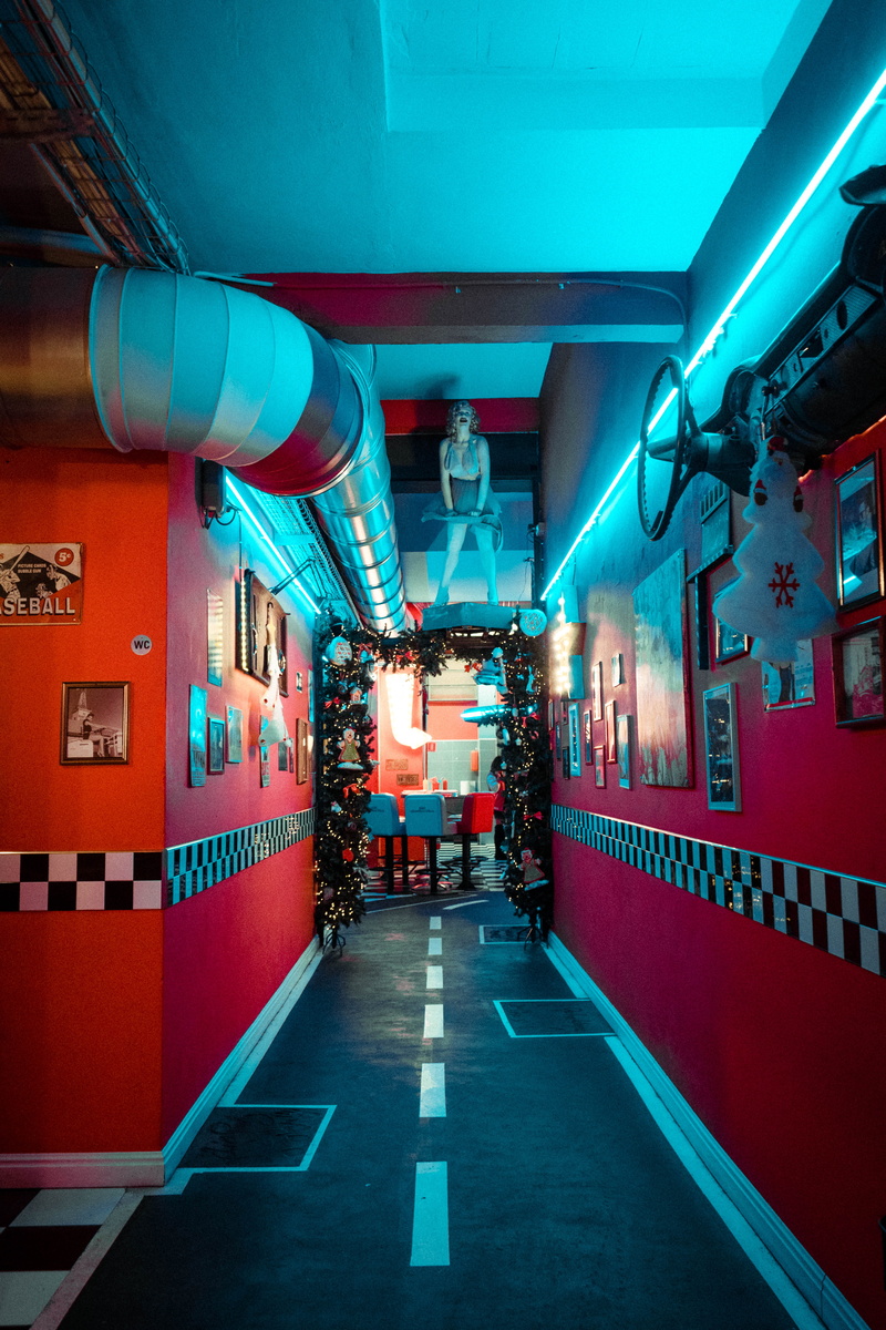 art, blue, lighting equipment, neon, train - vehicle, vehicle interior, real people, 1950 american diner, sofa, culture, night, photo, fries, public transportation