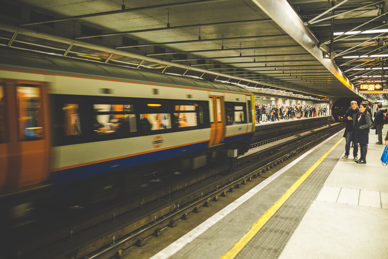 city, group, track, travel, railroad track, architecture, train - vehicle, mode of transportation, subway, orange, blue, arrival, indoors, real people