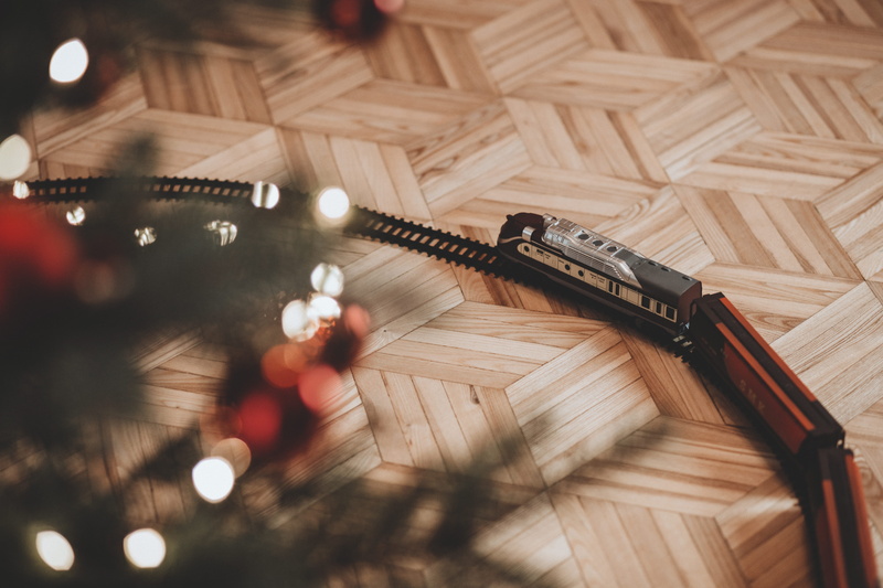 high angle view, arts culture and entertainment, action, communication, wooden flooring, plastic, night, built structure, christmas tree, light, real people