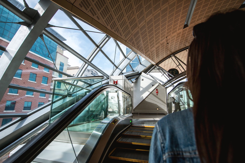 day, metro, escalator, transportation, one person, travel, station, escalators, adult, glass - material, 4K, real people, connection, motion, modern, mode of transportation