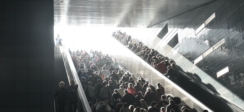 event, arts culture and entertainment, enjoyment, escalator, large group of people, stage, music, excitement, men, stairs, sunlight, city, women, trainstation