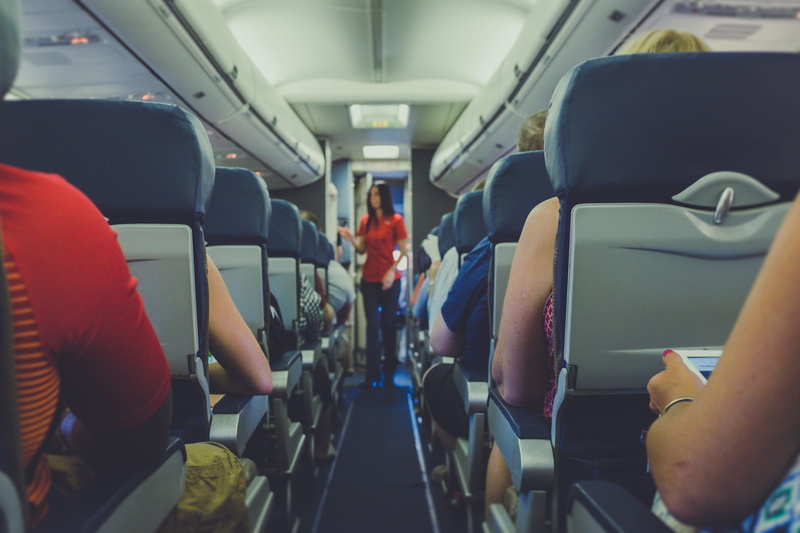 airplane, airplane seat, real people, hallway, group of people, attendant, men, journey, mode of transportation, passenger, vehicle interior, transportation