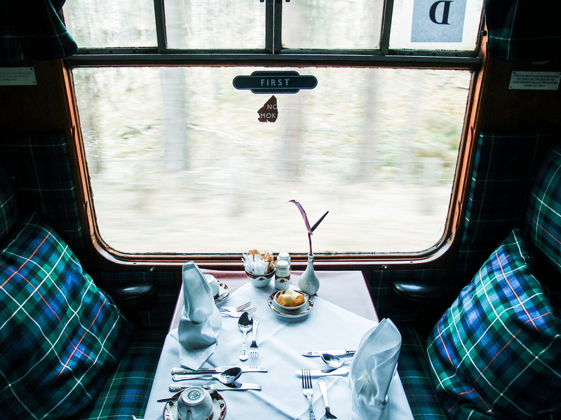 setting, table, indoors, glass, table setting, dinner, interiors, first, window seat, inside, cutlery, dine, daytime, cushion, vehicle interior, food and drink