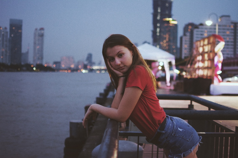 railings, skyscraper, illuminated, architecture, lifestyles, one person, 5K, city, front, photo, nighttime, water, sitting, river, fence, hairstyle, outdoors