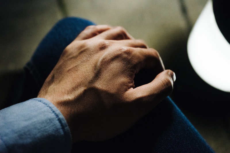 casual clothing, playing, human limb, human body part, jeans, finger, street, knee, personal perspective, shadow, close-up, lap, 5K, dark, hand on knee