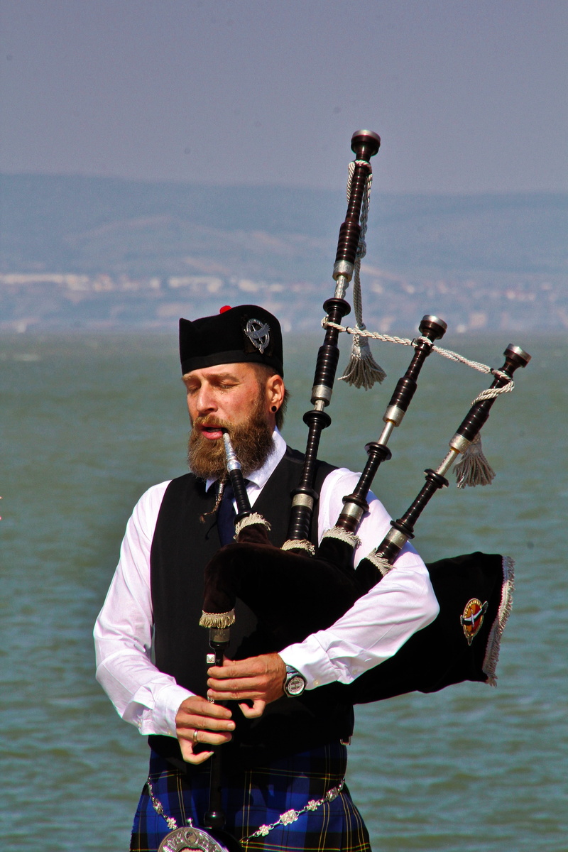 one person, 5K, outdoors, nature, water, bagpiper, culture, scotland, jock, bagpipes, sky, portrait, kilt, lifestyles, day, men, sea, waist up, checkered