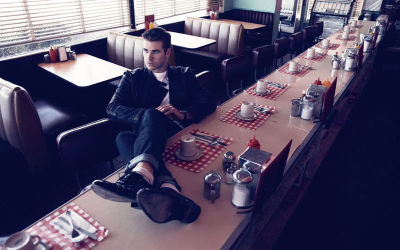 bar - drink establishment, liam hemsworth, denim, one Person, indoors, cafes, container, inside Of, drink, chair, food and drink, businessman, attitude