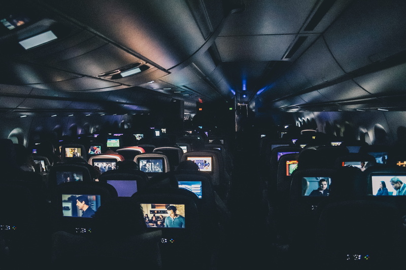 vehicle seat, air vehicle, steward, architecture, movie, interior, lighting equipment, seat, train, monitors, mode of transportation, entertainment, audience