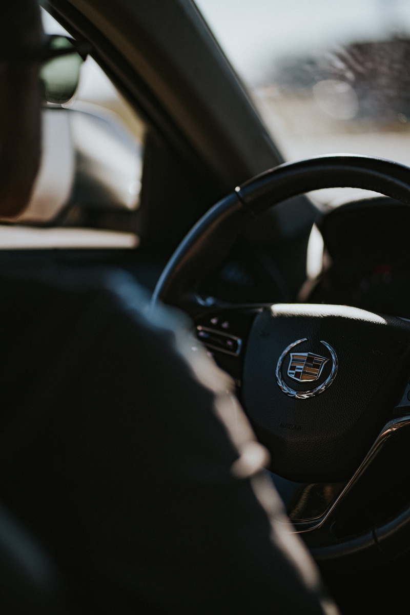 speedometer, driver, selective focus, headset, car, cadillac, motor vehicle, gearshift, cushion, no people, indoors, vehicle interior, car interior, 5K
