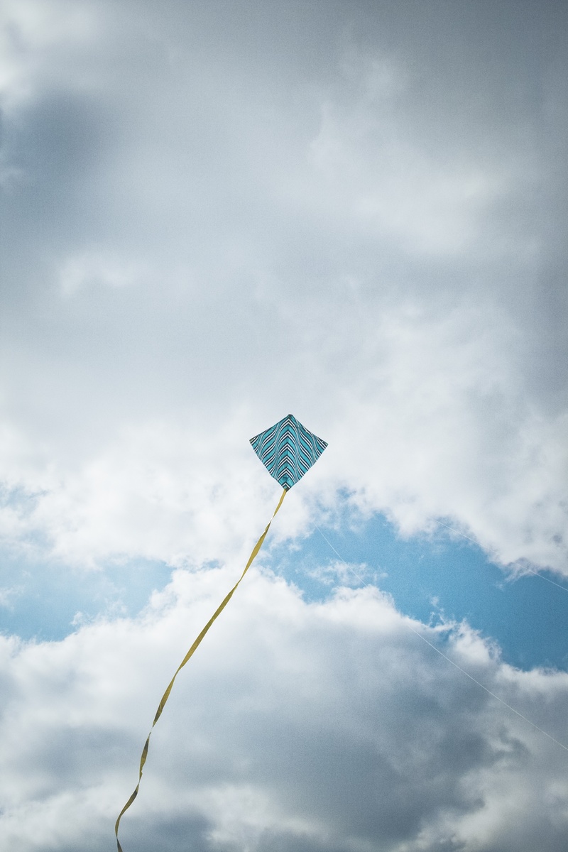 flag, environment, cloud - sky, outdoors, sky, fly, nature, toys, kids dragon, yellow, steering dragon, mid-air, no people, toy, blue, day, kite, low angle view