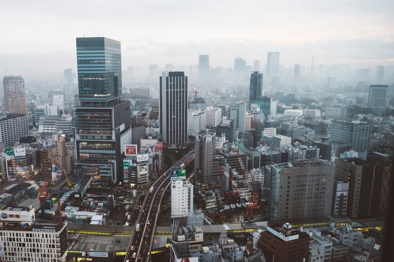 outdoors, sky, office building exterior, aerial, car, highways, tall, built structure, residential district, daytime, building exterior, urban skyline