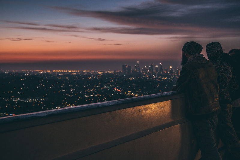 urban skyline, cloud - sky, travel, dawn, city life, building, standing, people, evening, outdoors, clouds, railing, buildings, dark, night view, silhouette