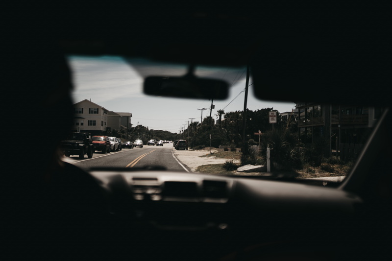 cityscape, motor vehicle, road, vehicle, outdoors, no people, mirror, view, road trip, car point of view, town, street, car, highway, tarmac, built structure