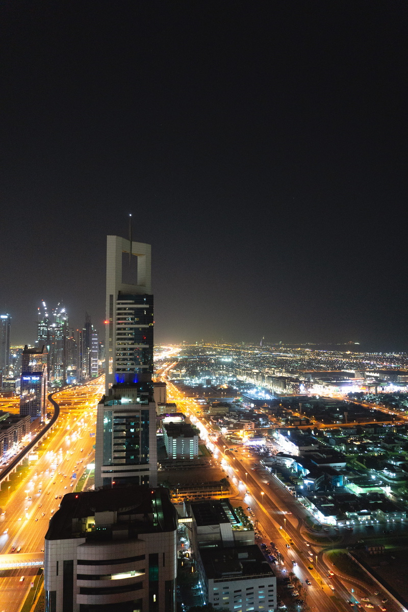 no people, modern, sky, night, city scape, tall - high, cityscape, dubai, motion, high angle view, office building exterior, city life, residential district