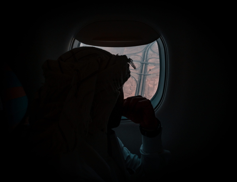 black, porthole, one person, human hand, standing, dark, leisure activity, muscat express highway, musical instrument, orange and teal, holding, moody