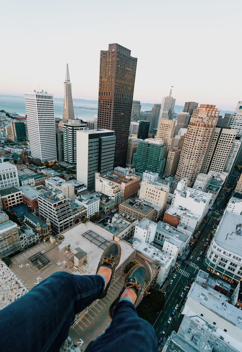 sitting on edge, architecture, daredevil, rooftopping, skyscraper, 2K, body part, low section, building exterior, skyline, human body part, tower, sitting on rooftop