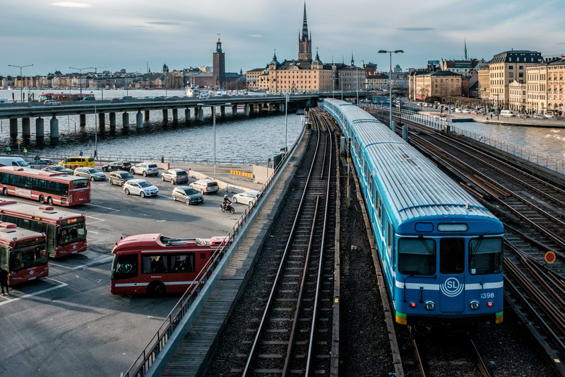 urban, land vehicle, city, subway train, trains, cloud - sky, public transportation, train, built structure, stockholm, day, nature, busses, building exterior
