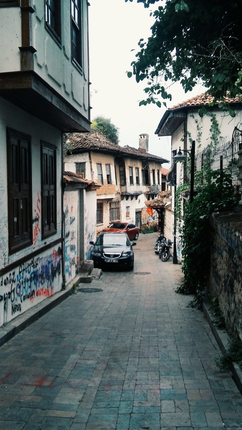 building exterior, the way forward, land vehicle, footpath, no people, graffiti, motor vehicle, white, architecture, sky, built structure, car, antalya
