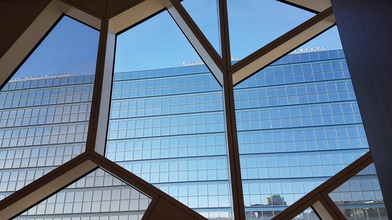 office building exterior, skylight, window, library, design, sky, low angle view, pattern, indoors, no people, transparent, ceiling, reflection, built structure