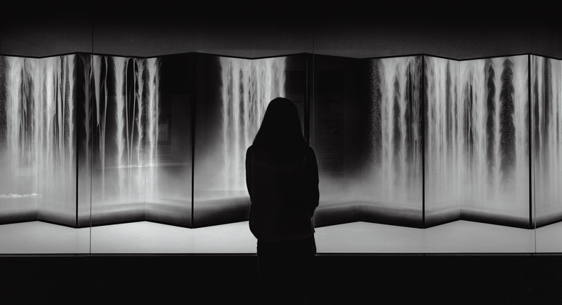 person, standing, thought, rear view, looking at view, wide, waterfall, contemplation, window, domestic room, young adult, adult, lifestyles, light, amazing