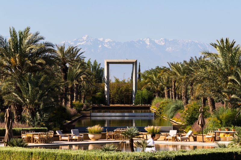 building exterior, tree, water, luxury, swimming pool, green color, outdoors, 4K, Mountains, palm, sky, sunlight, trees, monument, beauty in nature, Mandarin Oriental