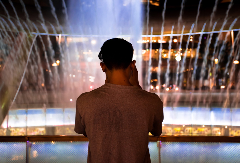 built structure, lighting equipment, adult, suntec, standing, waist up, indoors, person, central, illuminated, city, focus on foreground, men, singapore