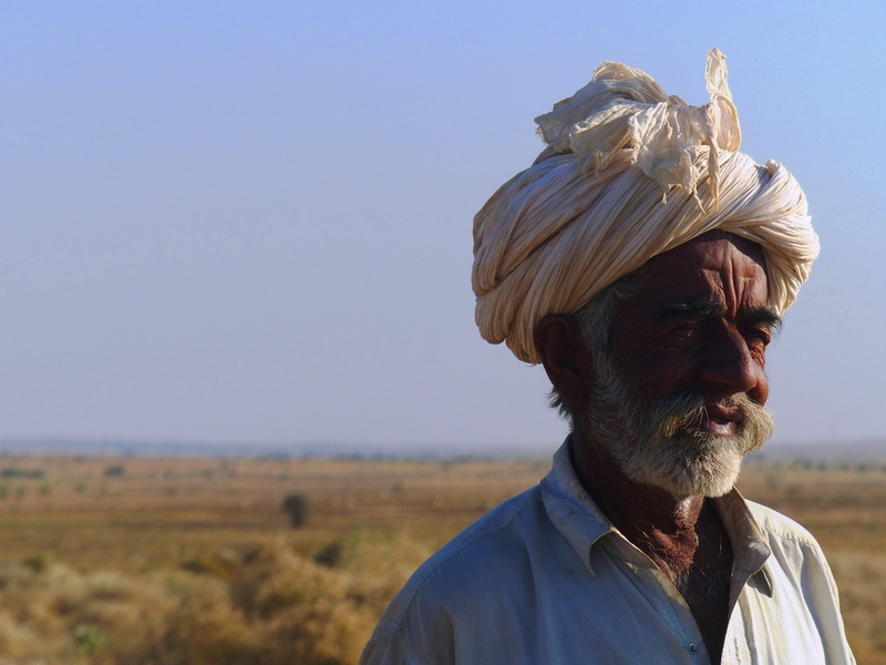 day, sky, nature, senior men, one person, clothing, portrait, jaisalmer, blue, senior adult, men, facial hair, sunlight, copy space, white hair, headshot