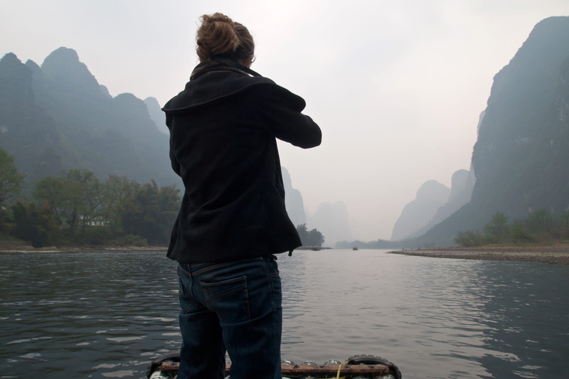 river, fog, standing, yangdi, one person, mountains, leisure activity, woman, sky, karsts, water, looking at view, cruise, china, mossad, tranquility, rock
