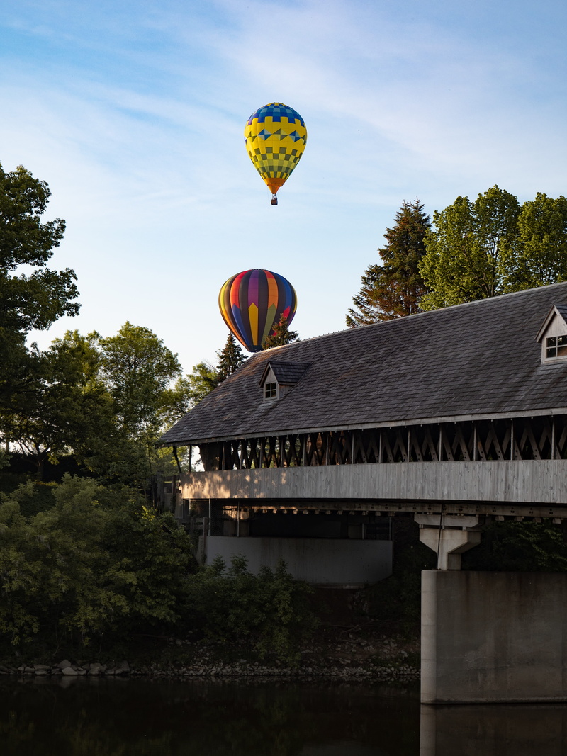 low angle view, balloons, air, transportation, adventure, hot air balloon, architecture, color, balloon, two, hot, sky, united states, building, day, river
