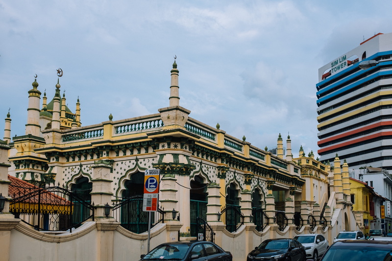 travel destinations, film, building exterior, surrounded, little india, worship, architectural column, history, vehicle, singapore, travel, building, vehicles