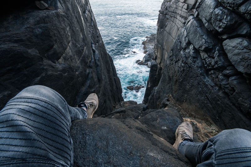 clothing, cliff, gray, day, low section, leisure activity, human leg, limestone, human foot, sea, jeans, rock, slate, wearing, nature, rock - object, ocean