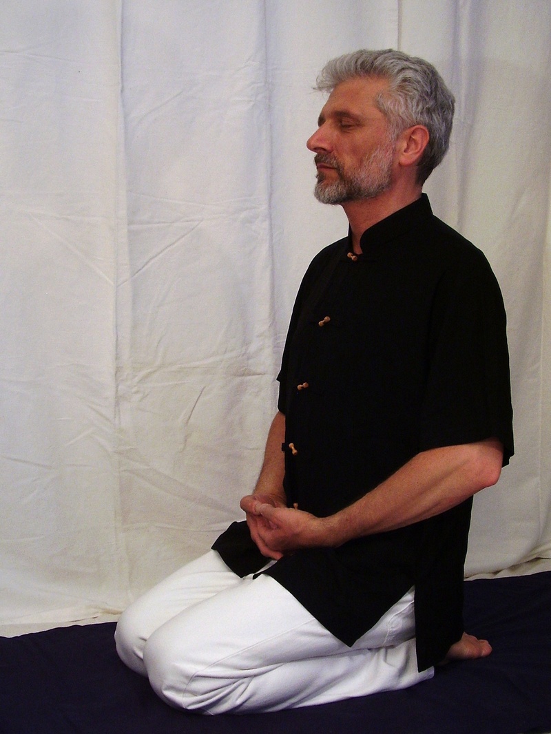 standing, mature men, looking away, zazen, one person, wall - building feature, clothing, buddhist, meditation, lifestyles, meditation seat, real people