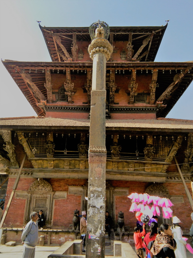 architectural column, travel destinations, day, building, built structure, men, patan durbar square, group of people, sky, buildings, history, religion