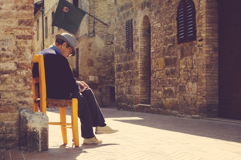 architecture, cobblestone, outdoors, old, man, cultures, street, young adult, yellow, clothing, chair, young men, males, full length, mid adult, building exterior