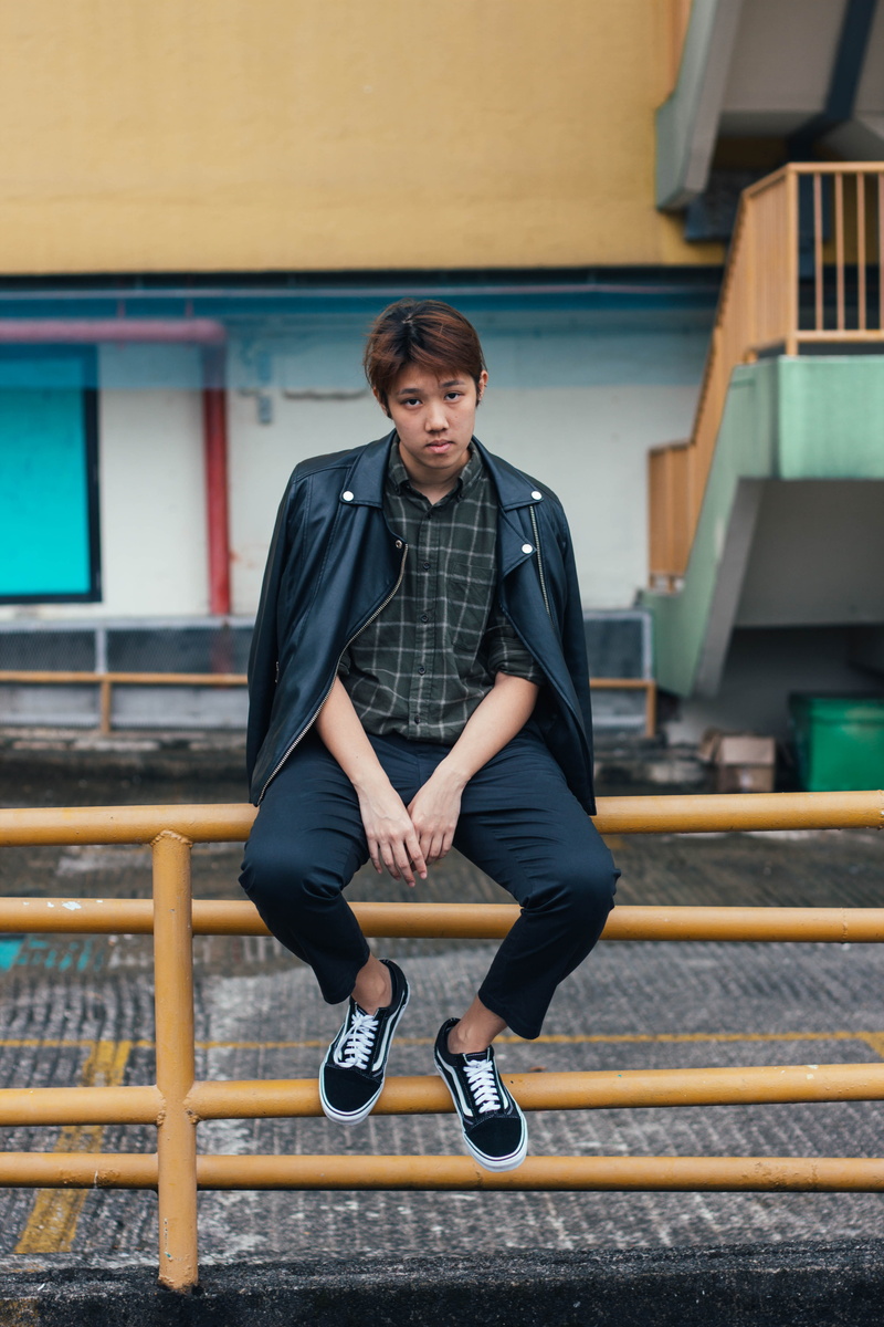 bright, cool, male, one person, day, blur, young men, full length, looking, contemplation, outdoors, street, industrial, front view, architecture, sitting