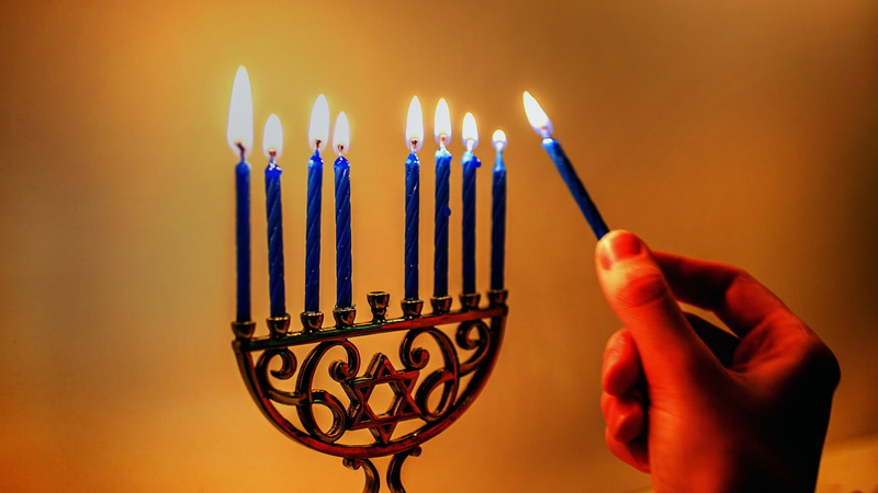 holding device, candelabrum, birthday candles, finger, menorah, candle, indoors, fire, celebration, close-up, candlestick, anniversary, heat - temperature