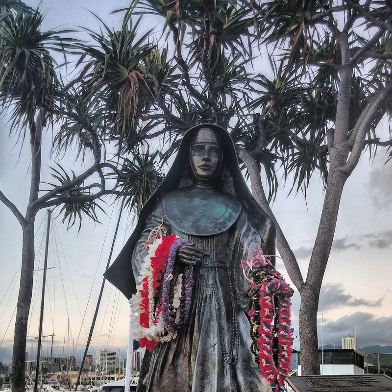 plant, palm tree, human representation, male likeness, sacred, sky, grace, prayer, tropical climate, statue, art and craft, representation, outdoors, marianne