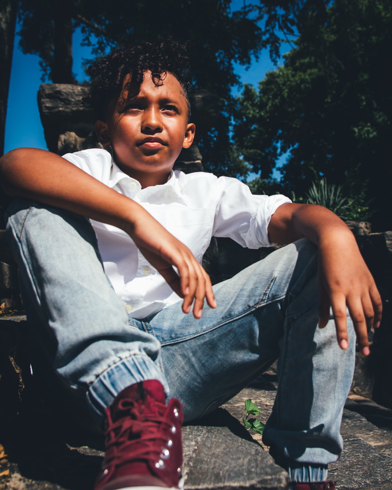 white, looking, child, sit, blue, ground, front view, nature, curly hair, full length, leisure activity, casual clothing, footwear, hairstyle, contemplation