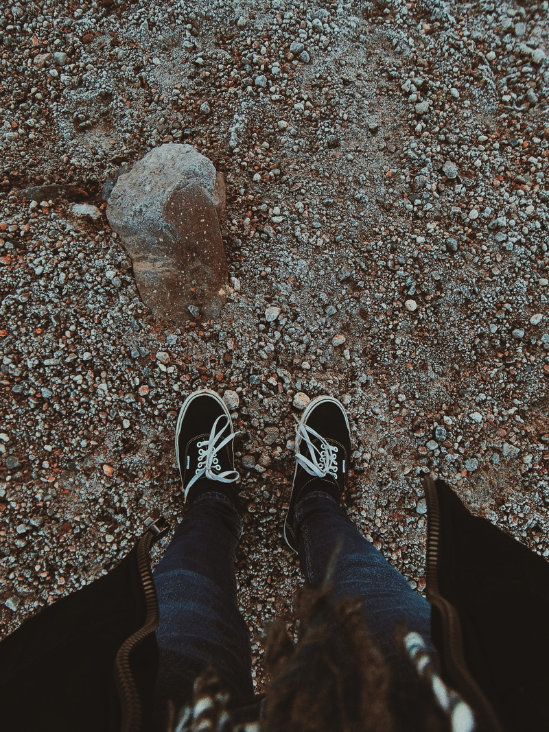 street, standing, jeans, human foot, personal perspective, men, unrecognizable person, one person, footwear, rocks, blue, person, human body part, directly above