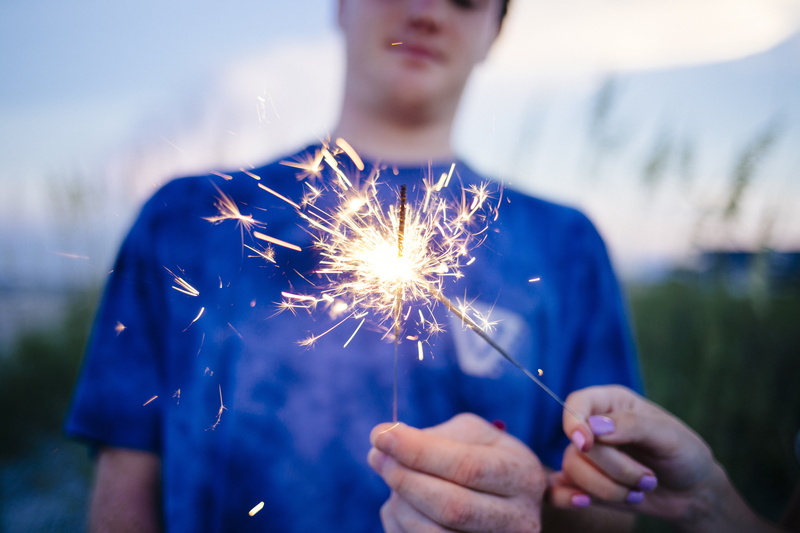 light, girl, celebration, portrait, grass, human body part, outdoors, people, sparks, males, men, burning, adults only, blue, focus on foreground, human hand