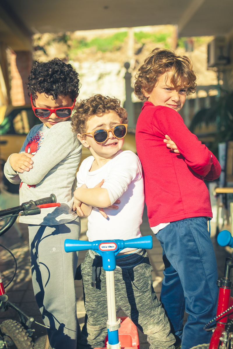 focus on foreground, scooters, pictures, females, boy, males, standing, mother, casual clothing, bonding, playing, funny, men, two people, three quarter length