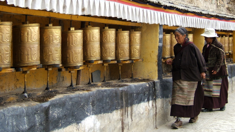 real people, lifestyles, walking, 4K, people, clothing, rear view, incidental people, adult, buddhism, prayer wheels, architectural column, traditional clothing