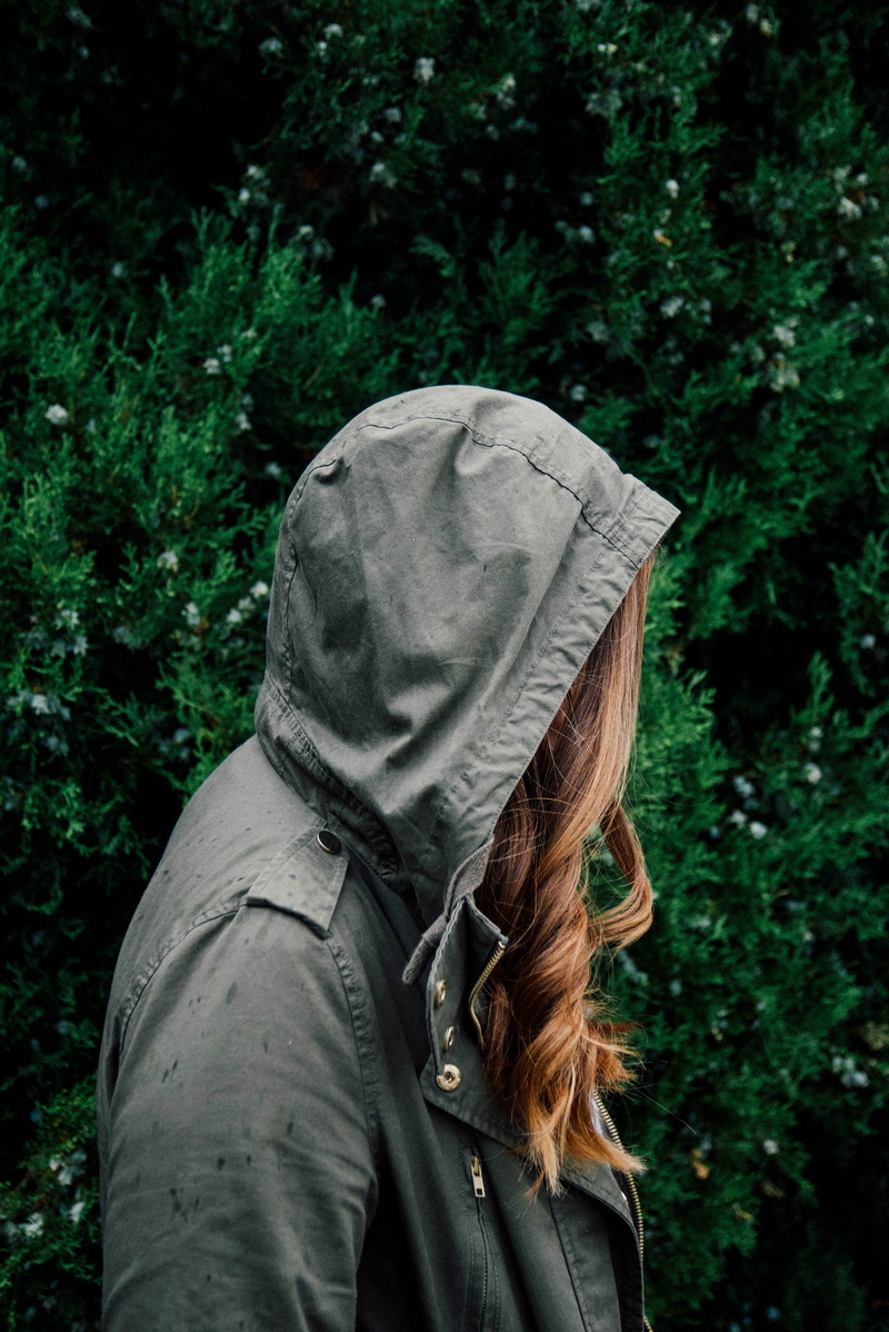 focus on foreground, waist up, adults only, lifestyles, clothing, hooded, near, warm clothing, hair, outdoors, wearing, 5K, adult, one Person, forest